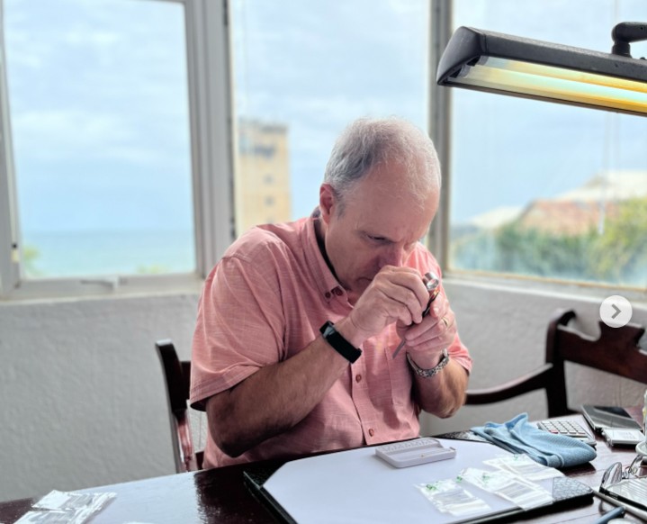 Client examining gems at AWA Buying Office with Indian Ocean view